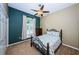 Cozy bedroom with leafy wallpaper, ceiling fan, large window and a comfortable bed at 1032 Rosetree Ln, Tarpon Springs, FL 34689