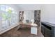 Contemporary home office features sleek desk, ample shelves, and large windows for natural light at 1032 Rosetree Ln, Tarpon Springs, FL 34689