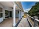 Covered patio with ceiling fan and white columns overlooking the backyard at 1032 Rosetree Ln, Tarpon Springs, FL 34689