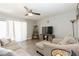 Spacious living room with beige sofas, a TV, and a ceiling fan at 5171 Corvette Dr, Tampa, FL 33624