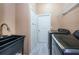 Bright laundry room, with washer, dryer, and utility sink at 1032 Rosetree Ln, Tarpon Springs, FL 34689