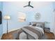 Relaxing bedroom featuring a gray bed and modern decor at 1032 Rosetree Ln, Tarpon Springs, FL 34689