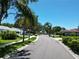 Residential street lined with lush landscaping and homes at 1638 Polo Club Dr, Tarpon Springs, FL 34689