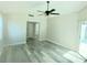 Primary bedroom with sliding glass doors and ceiling fan at 1638 Polo Club Dr, Tarpon Springs, FL 34689