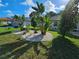 Landscaped yard with tropical plants and rock at 1638 Polo Club Dr, Tarpon Springs, FL 34689