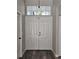 Bright entryway with double doors and wood floors at 1638 Polo Club Dr, Tarpon Springs, FL 34689