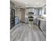 Open concept kitchen with stainless steel appliances and gray cabinets at 1638 Polo Club Dr, Tarpon Springs, FL 34689