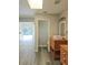 Bathroom with a single sink vanity, toilet, and access to other rooms at 1638 Polo Club Dr, Tarpon Springs, FL 34689