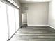 Bright living room with sliding glass doors and wood-look floors at 1638 Polo Club Dr, Tarpon Springs, FL 34689