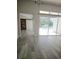 Living area with vinyl flooring, barn door, and view of the patio at 1638 Polo Club Dr, Tarpon Springs, FL 34689