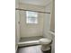 Bathroom with a shower, toilet, and window at 1638 Polo Club Dr, Tarpon Springs, FL 34689