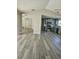Open living room and kitchen with vaulted ceilings and wood-look floors at 1638 Polo Club Dr, Tarpon Springs, FL 34689