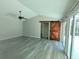 Spacious living room with vaulted ceiling, barn door, and sliding glass doors at 1638 Polo Club Dr, Tarpon Springs, FL 34689