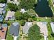 Aerial showcasing homes, pools, and a lake at 1638 Polo Club Dr, Tarpon Springs, FL 34689