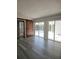 Living area with sliding glass doors, barn door, and wood-look floors at 1638 Polo Club Dr, Tarpon Springs, FL 34689