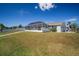 Spacious backyard with a screened enclosure and lush lawn at 910 Spindle Palm Way, Apollo Beach, FL 33572