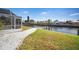 Landscaped backyard with canal access and dock at 910 Spindle Palm Way, Apollo Beach, FL 33572