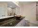 Bathroom boasts a vessel sink, granite countertop and tiled shower at 910 Spindle Palm Way, Apollo Beach, FL 33572