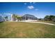 Rear exterior view showing canal-side yard at 910 Spindle Palm Way, Apollo Beach, FL 33572