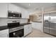 Kitchen with stainless steel appliances and granite countertops at 910 Spindle Palm Way, Apollo Beach, FL 33572