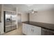 Stainless steel refrigerator in kitchen with granite island at 910 Spindle Palm Way, Apollo Beach, FL 33572
