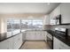 Updated kitchen featuring white cabinets, granite counters, and water views at 910 Spindle Palm Way, Apollo Beach, FL 33572