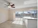 Kitchen with island, white cabinets, and access to patio at 910 Spindle Palm Way, Apollo Beach, FL 33572