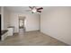 Living room with wood-look floors and access to the kitchen at 910 Spindle Palm Way, Apollo Beach, FL 33572