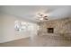 Open living room with stone fireplace and kitchen view at 910 Spindle Palm Way, Apollo Beach, FL 33572