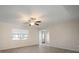 Bright living room with hardwood floors, ceiling fan, and view to kitchen at 910 Spindle Palm Way, Apollo Beach, FL 33572