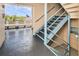Indoor stairwell with blue railings and tiled floors at 2850 59Th S St # 204, Gulfport, FL 33707