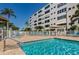 Community pool with lounge chairs and surrounding building at 2850 59Th S St # 204, Gulfport, FL 33707