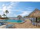 Inviting pool area with lounge chairs and tiki umbrellas at 2850 59Th S St # 204, Gulfport, FL 33707