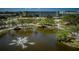 Picturesque pond with fountain, landscaping, and nearby condo building at 2850 59Th S St # 204, Gulfport, FL 33707