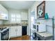 Well-equipped kitchen featuring white cabinets and granite countertops at 2850 59Th S St # 204, Gulfport, FL 33707