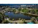 Arial view of a pond with lush green trees and walkway at 2850 59Th S St # 204, Gulfport, FL 33707