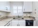 Kitchen corner with granite countertop and white cabinets at 2850 59Th S St # 204, Gulfport, FL 33707