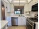 White kitchen with stainless steel appliances and pass-through at 1280 Mission Cir # 45C, Clearwater, FL 33759