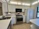 Bright kitchen with white cabinets and stainless steel appliances at 1280 Mission Cir # 45C, Clearwater, FL 33759
