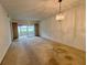 Spacious living room with large window and chandelier at 1280 Mission Cir # 45C, Clearwater, FL 33759
