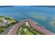 Community aerial view with docks and lush landscaping along the shore, beautiful bay views at 129 Brent Cir, Oldsmar, FL 34677