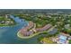 Aerial view of the condo complex on the waterfront with mature landscaping at 129 Brent Cir, Oldsmar, FL 34677