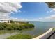 A stunning balcony ocean view with lush foliage surrounding a waterfront property at 129 Brent Cir, Oldsmar, FL 34677