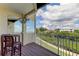 Relaxing balcony with canal view, outdoor dining table and a reflective mirror at 129 Brent Cir, Oldsmar, FL 34677