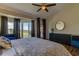 Bright bedroom featuring stylish decor, a comfortable bed, and sliding glass doors to the balcony at 129 Brent Cir, Oldsmar, FL 34677
