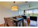 Open-concept dining area offering a view of the living space and balcony, perfect for entertaining at 129 Brent Cir, Oldsmar, FL 34677