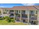 Rear exterior of the condo with multiple levels of screened in and covered patios at 129 Brent Cir, Oldsmar, FL 34677