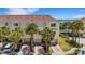 Beautiful townhouses with private garages and waterfront views, surrounded by palm trees and landscaped grounds at 129 Brent Cir, Oldsmar, FL 34677
