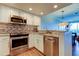 Updated kitchen with stainless steel appliances and open concept to the living and dining areas at 129 Brent Cir, Oldsmar, FL 34677