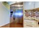 Bright kitchen featuring stainless steel refrigerator, white cabinetry, and stylish granite countertops at 129 Brent Cir, Oldsmar, FL 34677